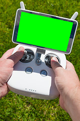 Image showing Hands Holding Drone Quadcopter Controller With Blank Green Scree