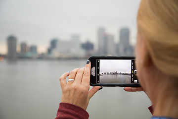 Image showing Woman Taking Pictures of The New Orleans Skyline with Her Smart 