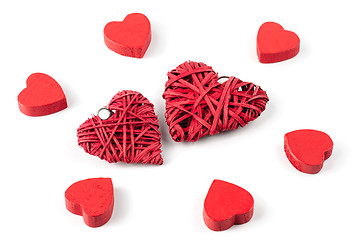 Image showing Group or red hearts isolated on white, six wooden and two strawy