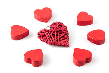 Image showing Group or red hearts isolated on white, six wooden and one strawy