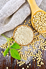 Image showing Flour soy in bowl with spoon on board top