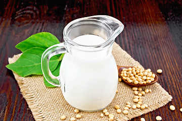 Image showing Milk soy in jug with beans on wooden board