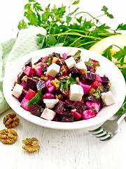 Image showing Salad with beetroot and feta in plate on board