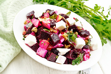 Image showing Salad with beetroot and apple in plate on light board