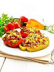 Image showing Pepper stuffed with meat and couscous in white plate on light bo