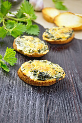 Image showing Sandwich of nettle on dark wooden board