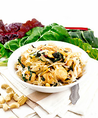 Image showing Funchoza with chard and cashew in bowl on board