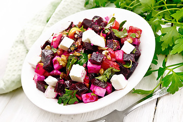 Image showing Salad with beetroot and feta in plate on table