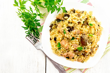 Image showing Risotto with mushrooms and chicken on light board top