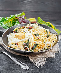 Image showing Funchoza with chard and meat in pan on table