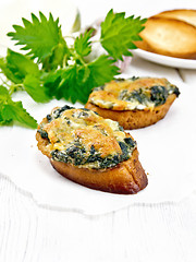 Image showing Sandwich of nettle and cheese on wooden board