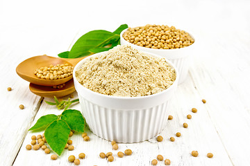 Image showing Flour soy with soybeans and leaf on wooden board