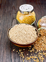 Image showing Flour linen in bowl with seeds in jars on board