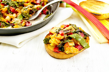 Image showing Bruschetta with chard and orange on board