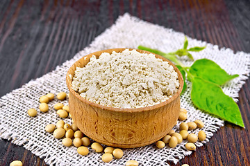 Image showing Flour soy in bowl with leaf on dark board