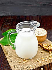 Image showing Milk soy in jug with flour and leaf on board