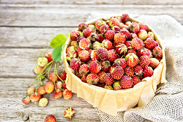 Image showing Strawberries in box on wooden board