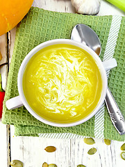 Image showing Soup-puree pumpkin with cream in white bowl on napkin top