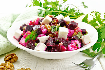 Image showing Salad with beetroot and apple in plate on board