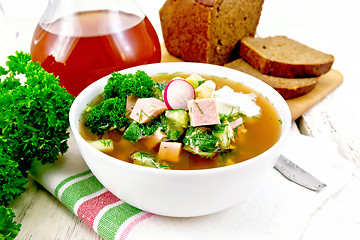 Image showing Okroshka in white bowl on light wooden board