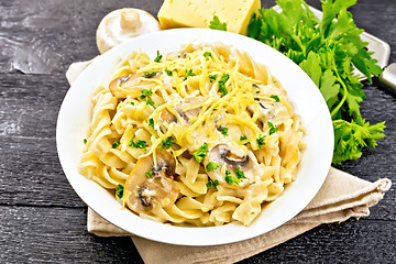 Image showing Fusilli with mushrooms in plate on black board