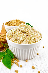 Image showing Flour soy with soybeans on wooden board