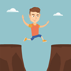 Image showing Sportsman jumping over the cliff.