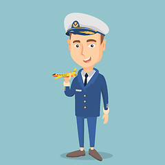 Image showing Cheerful airline pilot with model of airplane.