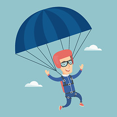 Image showing Young happy man flying with a parachute.