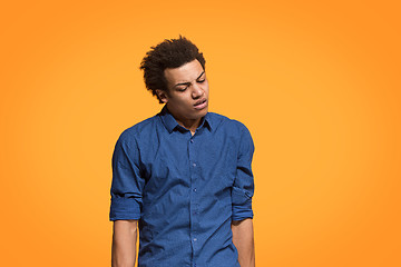 Image showing Beautiful bored man bored isolated on orange background