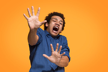 Image showing Portrait of the scared man on orange