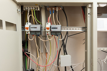 Image showing Two electronic electrical meters and a junction box