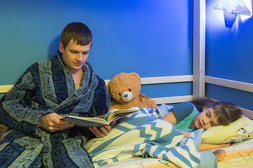 Image showing Dad Tells Sleeping Daughter a Bedtime Story