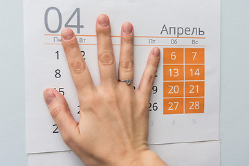 Image showing Hand closed weekdays on a sheet of calendar