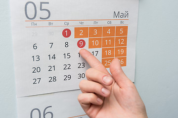 Image showing The hand points to the long May holidays holiday in the wall calendar