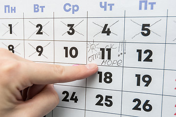 Image showing Hand indicates the day on the calendar with the inscription vacation