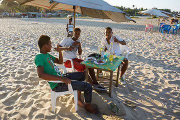 Image showing Malagasy teenagers boys resting on the beach