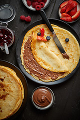 Image showing Delicious chocolate homemade pancakes on black ceramic plate