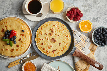 Image showing Delicious pancakes on stone frying pan. Placed on table with various ingredients