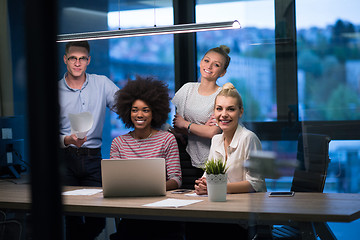 Image showing Multiethnic startup business team in night office