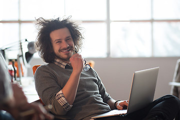 Image showing businessman working using a laptop in startup office