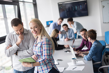 Image showing Two Business People Working With Tablet in office