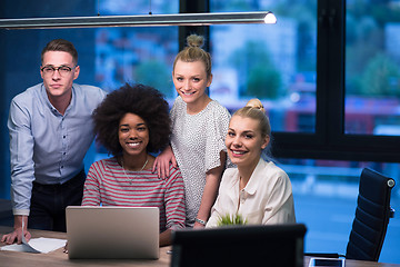 Image showing Multiethnic startup business team in night office