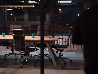 Image showing man working on laptop in dark office