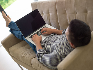 Image showing Man using laptop in living room