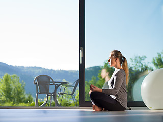 Image showing young woman doing morning yoga exercises