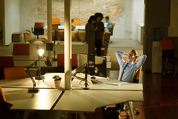 Image showing businessman relaxing at the desk