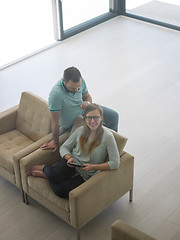 Image showing couple relaxing at  home with tablet computers