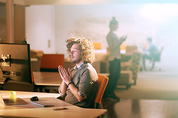 Image showing businessman relaxing at the desk