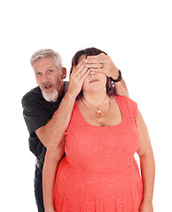 Image showing Man holds hands over wife's eyes